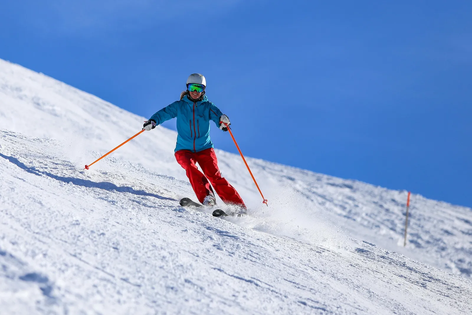 Skier carving on a groomed slope
